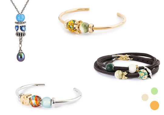 Collection of summery and colourful jewelry including necklaces and bracelets on a white background